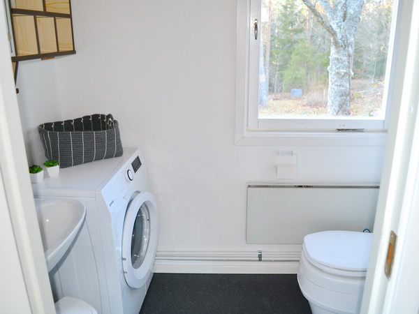 Badezimmer mit Biotoilette, Waschmaschine und Dusche